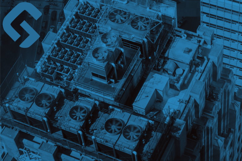 Industrial HVAC system units with large cooling fans installed on a commercial building rooftop